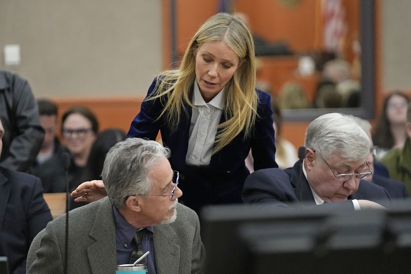  Gwyneth Paltrow speaks with retired optometrist Terry Sanderson, left, as she walks out of the courtroom