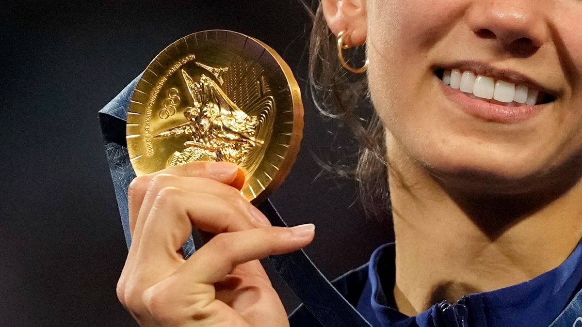 A close-up of a Paris 2024 gold medal as Team US Lee Kiefer celebrates winning the women's individual Foil competition 