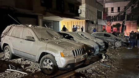 People inspect damaged cars in the southern suburbs of Beirut, Lebanon, Tuesday, July 30, 2024.