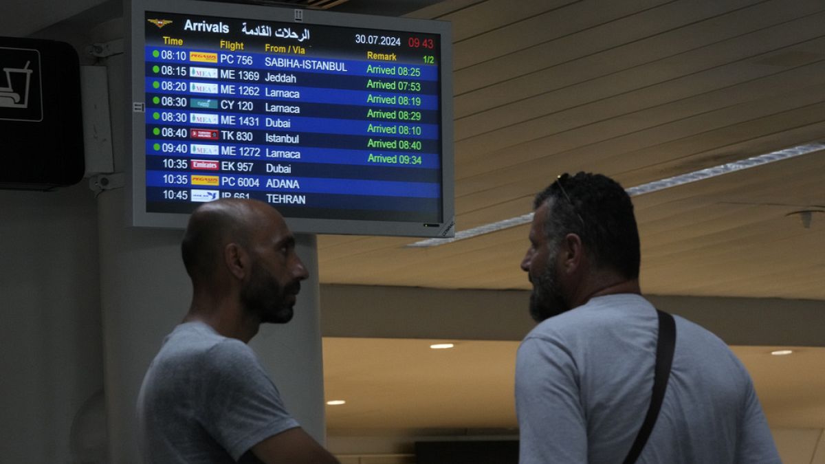 People wait at the arrival terminal of the Rafik Hariri International Airport in Beirut, Lebanon, Tuesday, July 30, 2024