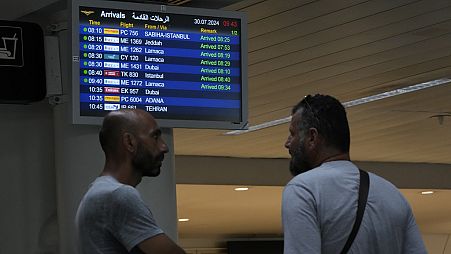 People wait at the arrival terminal of the Rafik Hariri International Airport in Beirut, Lebanon, Tuesday, July 30, 2024