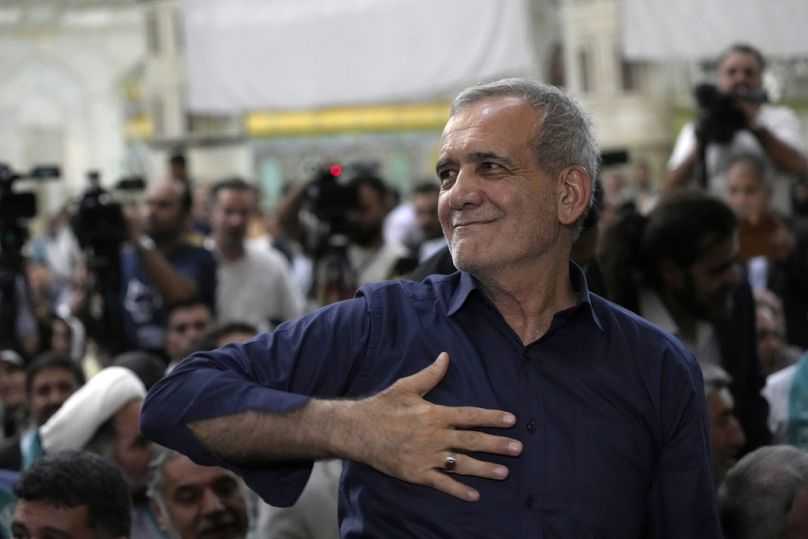  Iran's President-elect Masoud Pezeshkian greets his supporters in a meeting a day after the presidential election.