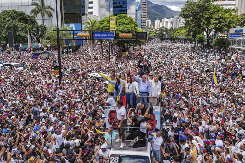 Opposition leader Maria Corina Machado and opposition candidate Edmundo Gonzalez ride atop a truck during a protest against official presidential election results