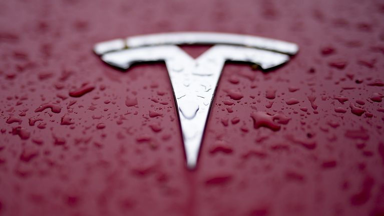 A Tesla logo is shown