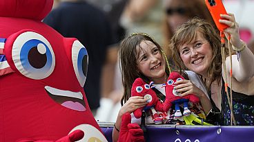 Phryge, the mascot of the Paris 2024 Olympic Games poses for a selfie with fans at the 2024 Summer Olympics, Sunday, July 28, 2024, in Nice, France.
