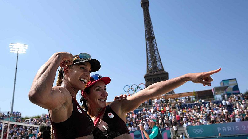 Canada's Brandie Wilkerson, left, and Canada's Melissa Humana-Paredes celebrate their victory over Paraguay in a beach volleyball match at the 2024 Summer Olympics