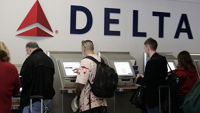 Passengers use Delta Air Lines' self check-in counter (file photo)