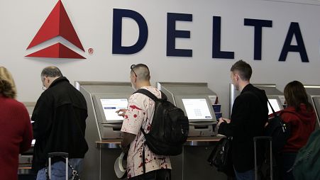 Passengers use Delta Air Lines' self check-in counter (file photo)