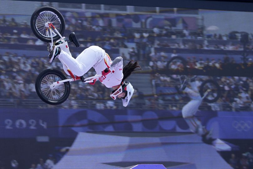 Deng Yawen, of China, performs a trick in front of a video screen during the cycling BMX freestyle women's park final at the 2024 Summer Olympics, Wednesday, July 31, 2024,