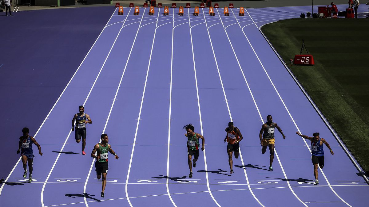 Athletes run on the track during a rehearsal at the Stade de France stadium on June 25, 2024, in Saint-Denis, outside Paris.