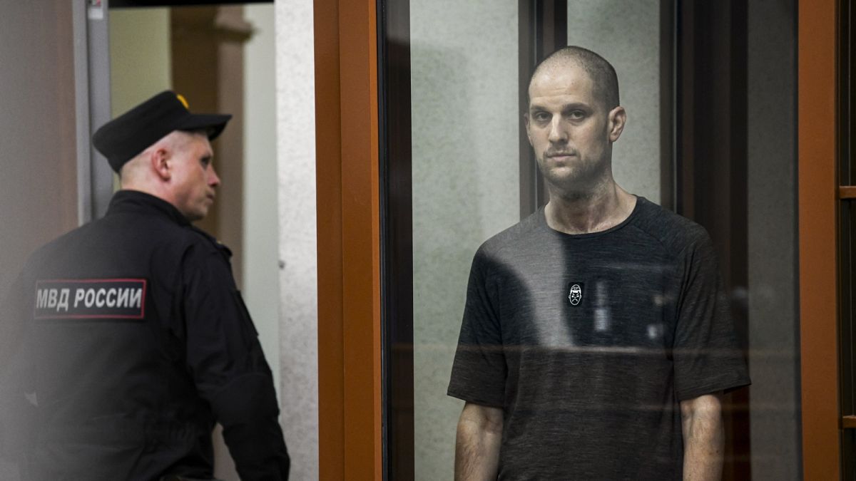 Wall Street Journal reporter Evan Gershkovich listens to verdict in a glass cage of a courtroom inside the building of "Palace of justice," in Yekaterinburg, Russia.