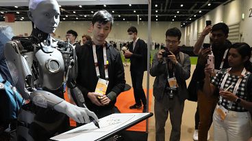 A robot interacts with visitors during the International Conference on Robotics and Automation ICRA in London,