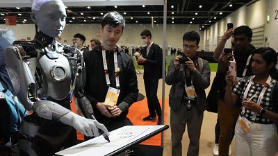 A robot interacts with visitors during the International Conference on Robotics and Automation ICRA in London,