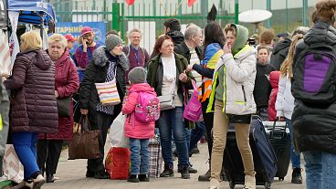 FILE - Refugees wait in a line after fleeing the war from neighbouring Ukraine at the border crossing in Medyka, southeastern Poland, 7 April 2022