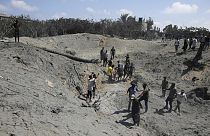 Palestinians search for bodies and survivors in a site hit by an Israeli bombardment on Khan Younis, southern Gaza Strip, Saturday, July 13, 2024.