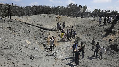 Palestinians search for bodies and survivors in a site hit by an Israeli bombardment on Khan Younis, southern Gaza Strip, Saturday, July 13, 2024.