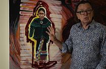 Joe Baker, a member of the Delaware Tribe of Indians and co-founder of the Lenape Center stands next to a painting of an Ohtas during an interview in his home in New York.