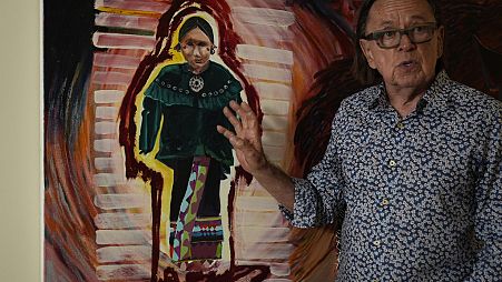 Joe Baker, a member of the Delaware Tribe of Indians and co-founder of the Lenape Center stands next to a painting of an Ohtas during an interview in his home in New York.