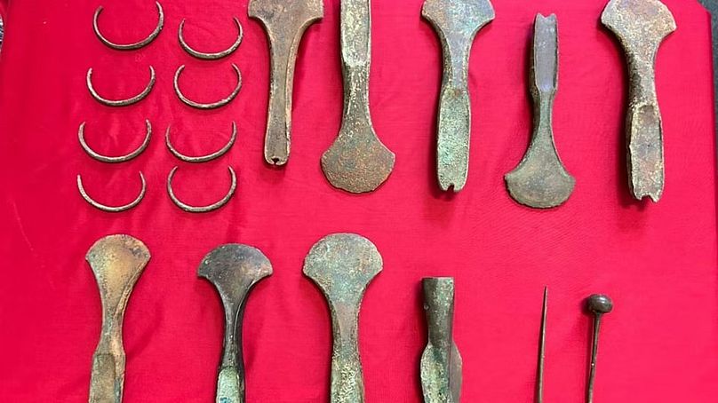 Artefacts discovered in Budyně nad Ohří, including axes, arm rings, pins, and a spearhead, dating back to around 1600 BC.