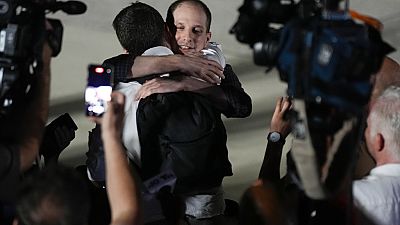 Reporter Evan Gershkovich receives an embrace from a colleague following his release as part of a 24-person prisoner swap between Russia and the United States on 01/08/2024