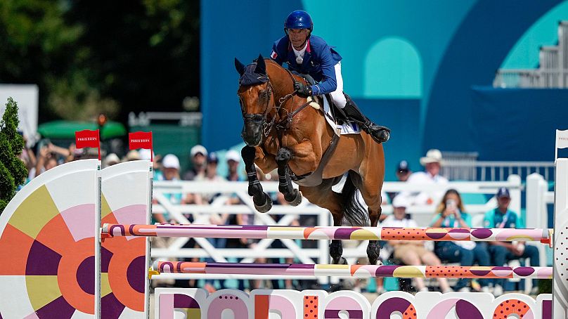 Karim Laghouag of France, riding Triton Fontaine, competes in the equestrian jumping at the 2024 Summer Olympics, 29 July 2024, in Versailles, France. 