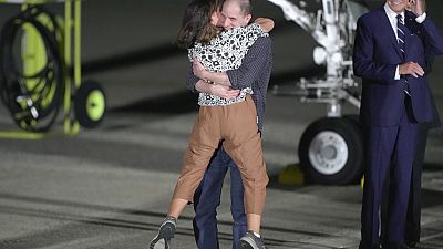 Reporter Evan Gershkovich hugs his mother, Ella Milman, as President Joe Biden, right, looks on at Andrews Air Force Base.