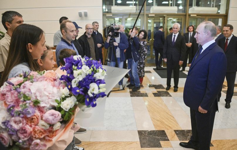 Russian President Vladimir Putin, right, greets released Russian prisoners and relatives at the Vnukovo government airport outside Moscow, Russia, Aug. 1, 2024.