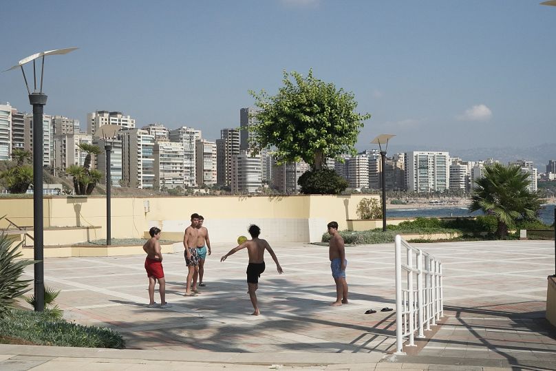 Children play football near the beach in Beirut, July 2024