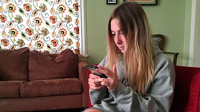 A student holding her phone.