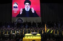 Hezbollah leader Sayyed Hassan Nasrallah speaks through a screen during Fouad Shukur's funeral in a southern suburb of Beirut, Lebanon, Aug. 1, 2024.