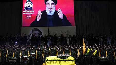 Hezbollah leader Sayyed Hassan Nasrallah speaks through a screen during Fouad Shukur's funeral in a southern suburb of Beirut, Lebanon, Aug. 1, 2024.