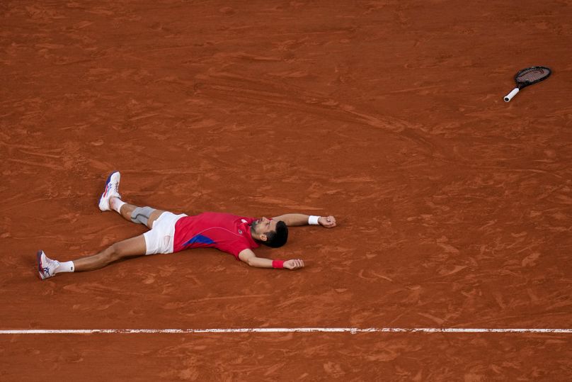 Novak Djokovic of Serbia celebrates after defeating Lorenzo Musetti of Italy in their men's singles semifinals tennis match