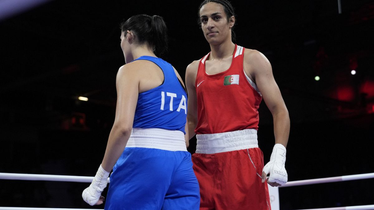 Algeria's Imane Khelif, right, walks beside Italy's Angela Carini after their women's 66kg preliminary boxing match at the 2024 Summer Olympics