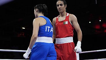 Algeria's Imane Khelif, right, walks beside Italy's Angela Carini after their women's 66kg preliminary boxing match at the 2024 Summer Olympics