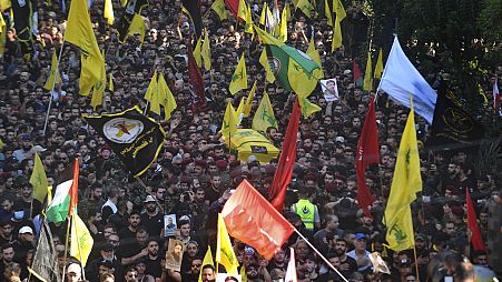 Mourners and Hezbollah fighters carry the coffin of their top commander Fouad Shukur, who was killed by an Israeli airstrike on Tuesday, July 30, during his funeral procession