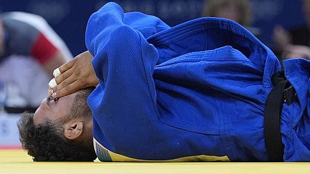 Afghanistan's Mohammad Samim Faizad reacts after their men -81kg elimination round match against Austria's Wachid Borchashvili i