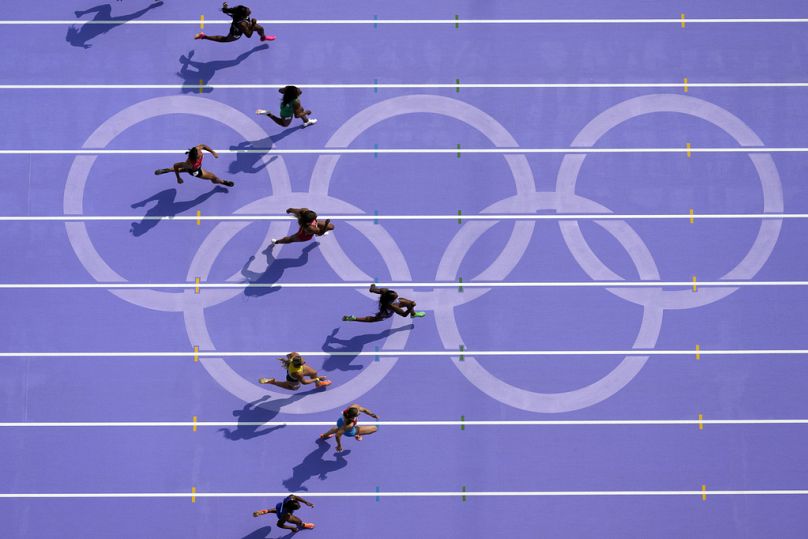 Sha'carri Richardson, right, of the United States, runs in women's 100-meter heat at the 2024 Summer Olympics, Friday, Aug. 2, 2024, in Saint-Denis, France. 