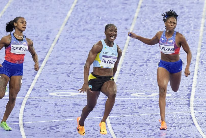 Saint Lucia's Julien Alfred celebrates winning the women's 100-m final at Saint Denis stadium in Paris