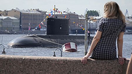 A submarine is anchored in the Neva River ahead Navy Day celebration in St. Petersburg, Russia, Thursday, July 25, 2024.