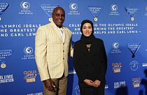 Former Olympian Carl Lewis, left, and representer of the IOC's Refugee Olympic Team Masomah Ali Zada arrives for the Sport for Peace Gala in Paris on Saturday