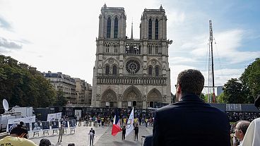 People gather for an interfaith event, outside Notre Dame Cathedral, in Paris, France, Sunday, Aug. 4, 2024.