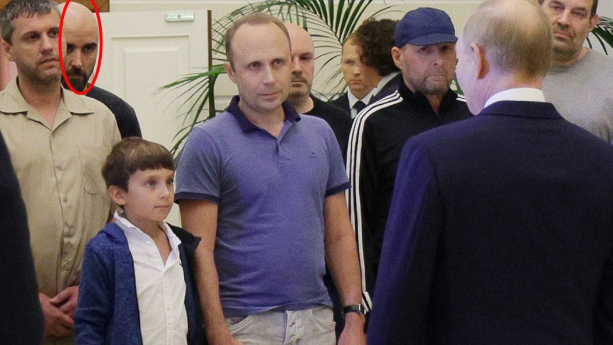 A man identified as Pablo González, a freelance journalist from Spain who had been based in Poland since 2019, second from left with shaved head, listens to Russian President