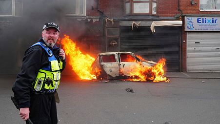 A car burns on Parliament Road, in Middlesbrough, England, during an anti-immigration protest on Sunday, Aug. 4, 2024. 