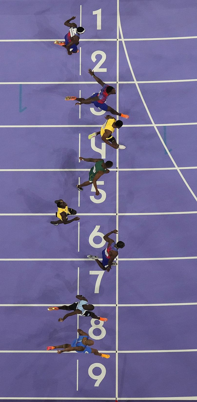 Noah Lyles, of the United States, in lane seven, wins the men's 100-meter final at the 2024 Summer Olympics, Sunday, Aug. 4, 2024, in Saint-Denis, France.