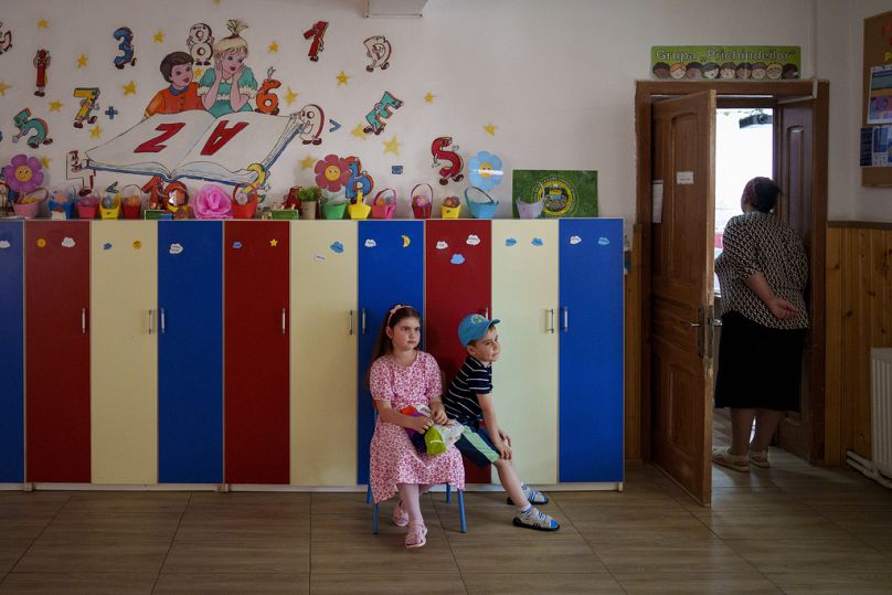 Children wait for their relatives to vote in European Parliament and local elections in Baleni, 9 June 2024