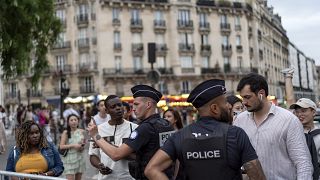 Police check the public for credentials to enter a security perimeter near the Eiffel Tower ahead of the 2024 Summer Olympics.