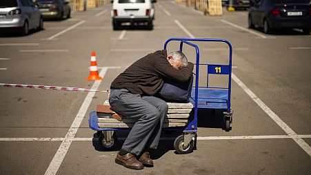 FILE: A man who fled from a small village near Polohy rests upon his arrival to a reception center for displaced people in Zaporizhzhia, 8 May 2022