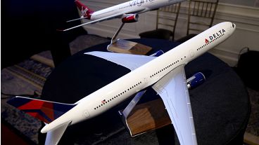 Model planes bearing the logos of Delta Airlines and Virgin Atlantic are displayed during a news conference in New York, Tuesday, Dec. 11, 2012. 