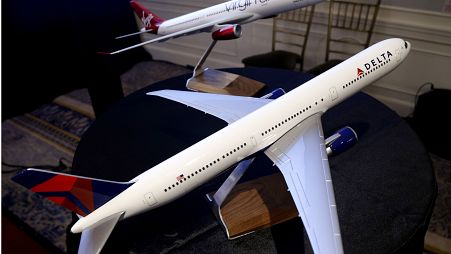 Model planes bearing the logos of Delta Airlines and Virgin Atlantic are displayed during a news conference in New York, Tuesday, Dec. 11, 2012. 