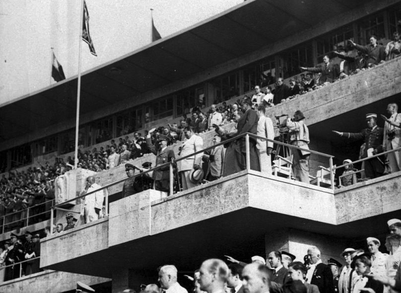 In this Aug. 2, 1936 file photo Adolf Hitler and Colonel General Hermann Goering are on the grand stand in the stadium watching events at the Olympics in Berlin